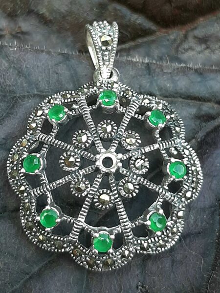 Emerald, marcasite. Silver. Diameter 3 cm.